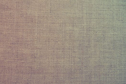 Fabric texture background. Colorful gradient fabric with weave. Natural slightly wrinkled look of the material. Uniform copy space background cotton canvas or woolen fabric laid evenly on the surface