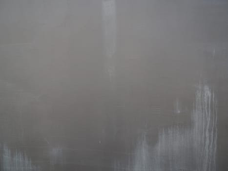 Gray concrete wall with plaster relief. Background texture.