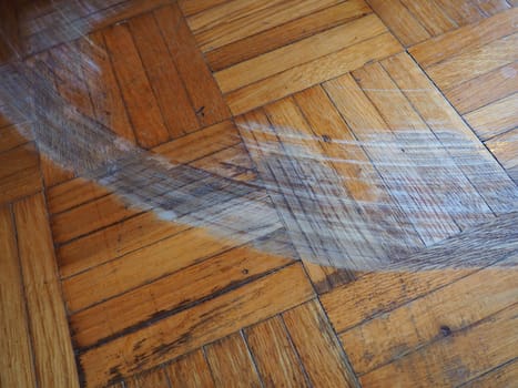 Scratched parquet flooring in the room. Scratches, chips and dents on the floor. Parquet in need of repair
