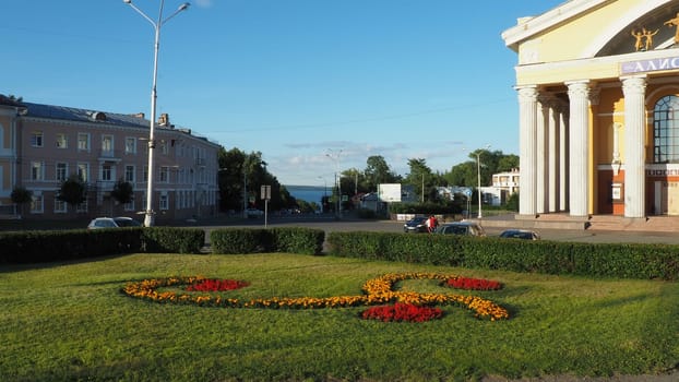 Musical Theater of the Republic of Karelia, Petrozavodsk. Passers-by are walking sunny evening on August 3, 2022 Park of Culture and Leisure. View of Lake Onega. Lawn with marigold flowers. Road signs