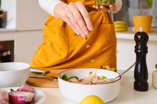 Closeup view of adding pumpkin seeds to probiotic salad