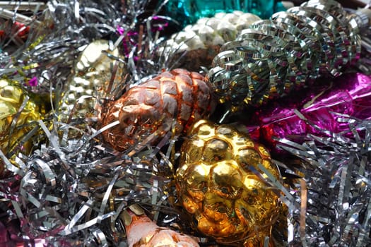 New Year and Christmas decorations, tinsel, boa, Christmas decorations. Multi-colored balls in the form of cones and baskets. Festive interior decoration. New Year or Christmas composition.