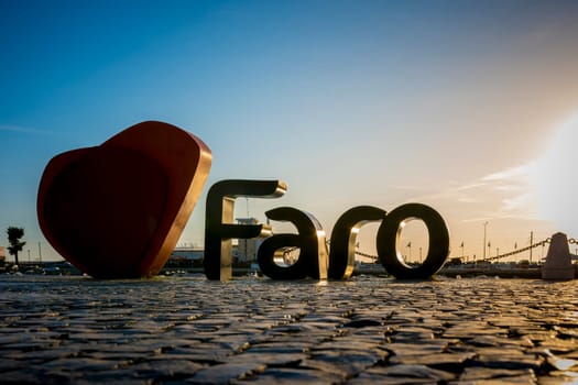 Faro, Portugal, September 2022: Sunset view on the I Love Faro Sign in the harbor of the city.