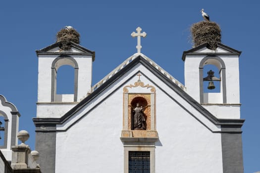 Faro, Portugal, September 2022: Stork nests on the tower of a Convento de Santo António dos Capuchos in Faro, Portugal