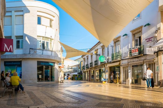 Faro, Portugal, September 2022: View on Faro cozy shopping street with suncovers.