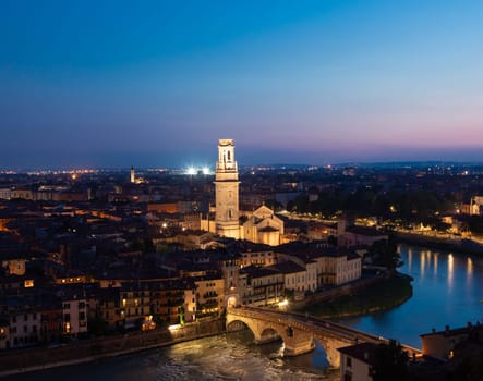 Verona, Italy - June 2022: panorama by night. Illuminated cityscape with scenic bridge