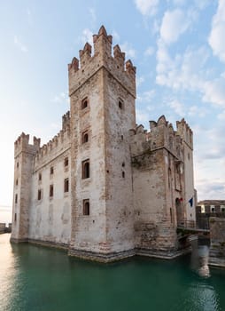 Sirmione, Italy - June 2022: Sirmione castle on Garda lake. Scenic mediaeval building on the water