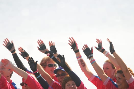 Dragon boat racers wave their hands to show unity.