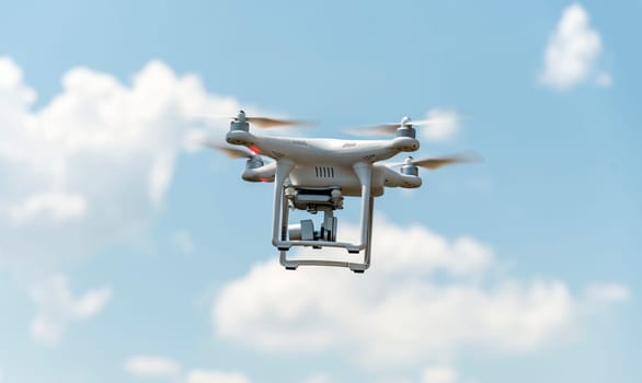 Drone with digital camera flying in the sky. Modern technology for aerial video and photography.