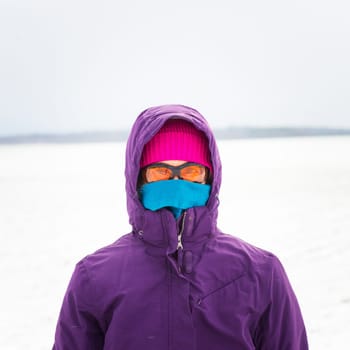 Woman walking in snow in winter clothes