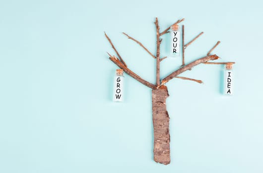 Grow your idea is standing on the bottles hanging on the tree, starting a new business, motivation and coaching concept, progress in building success