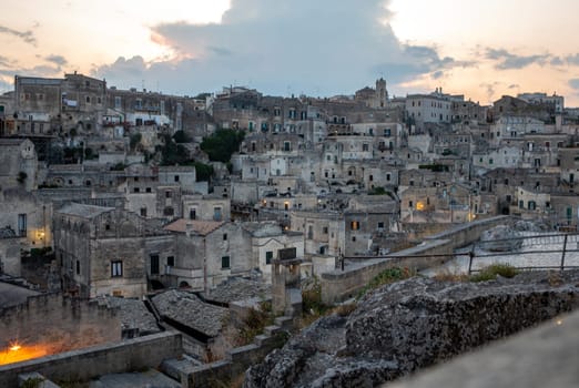 Evening view of the city of Matera  Italy  with the colorful lights highlighting old buildings in the Sassi di Matera a historic district in the city of Matera. Basilicata. Italy