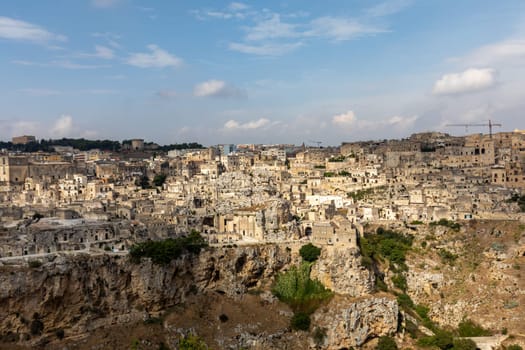 Panoramic view of Sassi di Matera a historic district in the city of Matera, well-known for their ancient cave dwellings from the Belvedere di Murgia Timone,  Basilicata, Italy
