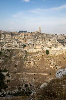 Panoramic view of Sassi di Matera a historic district in the city of Matera, well-known for their ancient cave dwellings from the Belvedere di Murgia Timone,  Basilicata, Italy