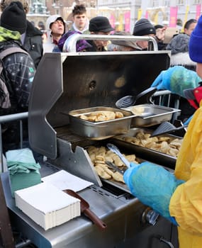 Krakow, Poland - Dec 18, 2022: Christmas Eve for poor and homeless on the Main Square in Cracow. The group Kosciuszko prepares the greatest eve in the open air in Krakow