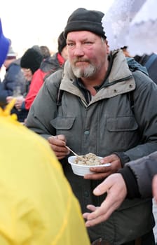Krakow, Poland - Dec 18, 2022: Christmas Eve for poor and homeless on the Main Square in Cracow. The group Kosciuszko prepares the greatest eve in the open air in Krakow