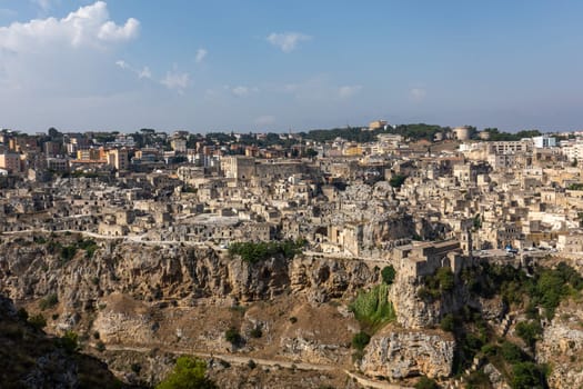 Panoramic view of Sassi di Matera a historic district in the city of Matera, well-known for their ancient cave dwellings from the Belvedere di Murgia Timone,  Basilicata, Italy