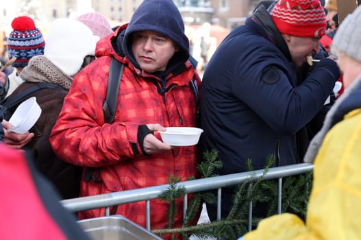Krakow, Poland - Dec 18, 2022: Christmas Eve for poor and homeless on the Main Square in Cracow. The group Kosciuszko prepares the greatest eve in the open air in Krakow