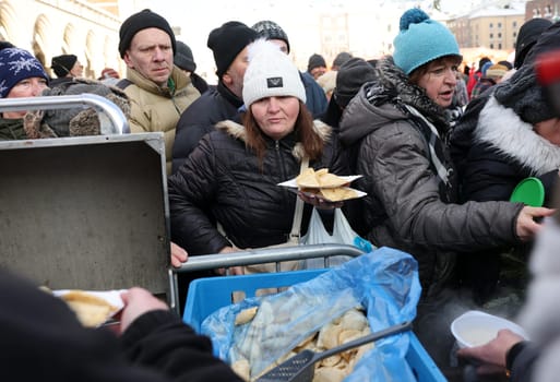 Krakow, Poland - Dec 18, 2022: Christmas Eve for poor and homeless on the Main Square in Cracow. The group Kosciuszko prepares the greatest eve in the open air in Krakow
