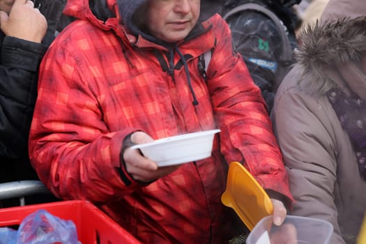 Krakow, Poland - Dec 18, 2022: Christmas Eve for poor and homeless on the Main Square in Cracow. The group Kosciuszko prepares the greatest eve in the open air in Krakow