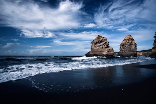 The black Ciraccio beach with the rock formations shaped by the wind on the northwest coast of the island of Procida in the Gulf of Naples