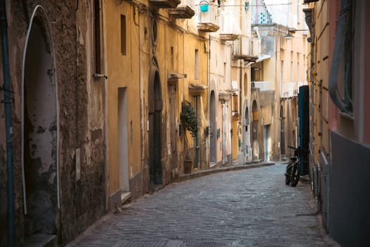 Procida island with colorful houses in small town street
