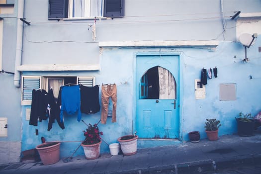 Procida island with colorful houses in small town street