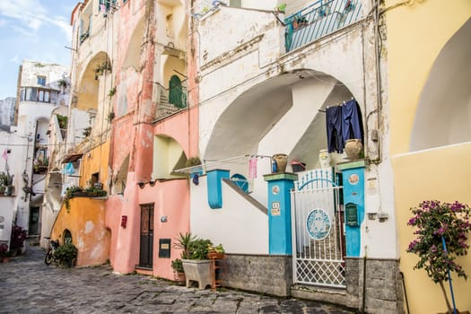 Procida island with colorful houses in small town street
