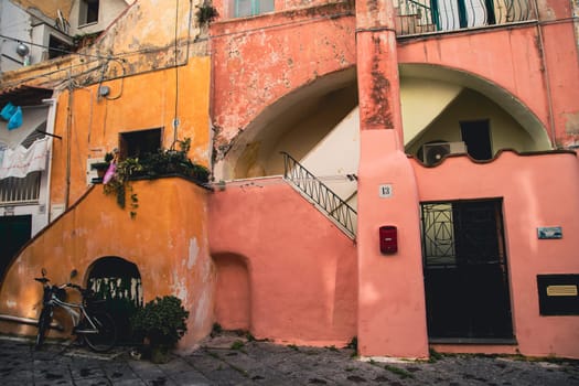 Procida island with colorful houses in small town street