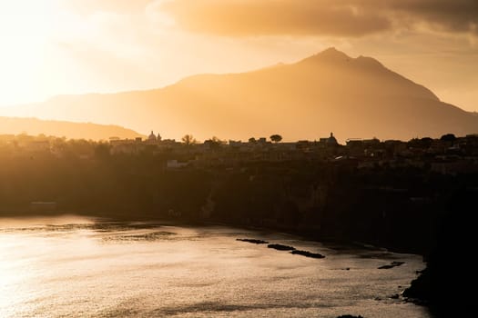 Magic sunset over Procida Island with Ischia island in the background.