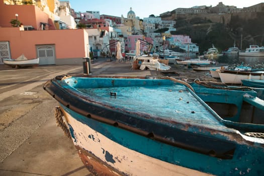 View of the Port of Corricella with lots of colorful houses on a sunny day in Procida Island, Italy.
