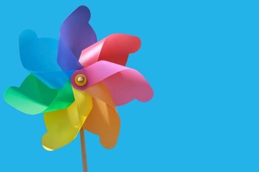 A plastic windmill with a wooden handle. Not a toy for children.