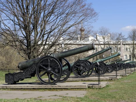 row of ancient bronze cannons in the fortress