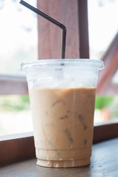 Iced coffee on wooden table, stock photo