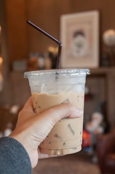Woman hold her iced coffee, stock photo