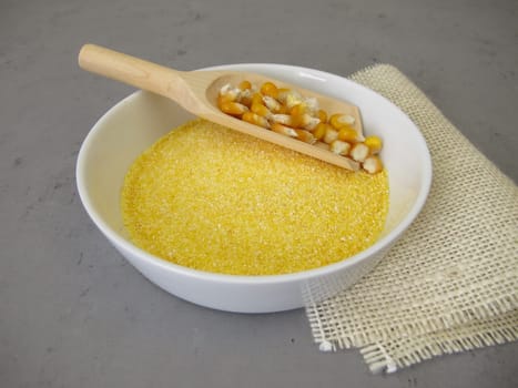 Corn semolina in a shallow bowl and maize kernels