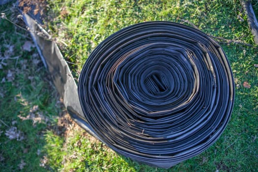 Rolled tape of flexible irrigation tubing system. Overhead view