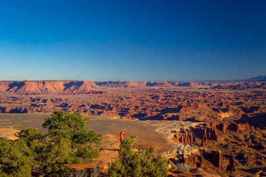 Tourist overlooking the majestic nature of Canyonlands in Utah. Beauty in nature.