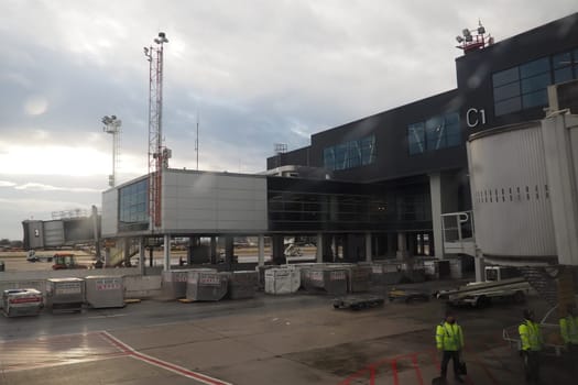 Belgrade, Serbia, January 19, 2023. Shot from the window of an aircraft moving across the airfield. Terminals and buildings of the airport Nikola Tesla in Surcin. International flights in the Balkans