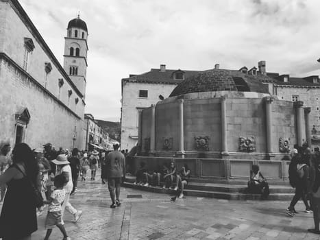 Big Onofrio Fountain, Velika Onofrijeva chesma, Dubrovnik, Croatia. Water supply established during the Quattrocento period. Numerous multinational happy tourists walk on the Stradun 14 August 2022.