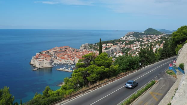Road traffic near Dubrovnik old town in Croatia. Dubrovnik Ragusa is a city in Croatia, the administrative center of the Dubrovnik-Neretva County. Top view from the observation deck on the rock