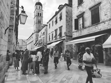 Stradun, Stradone is the main street of the historic city center of Dubrovnik in Croatia. architectural sights. A popular place for tourist walks. People are walking August 14, 2022 Black and white.