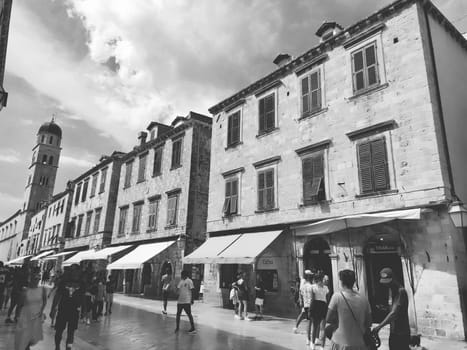 Stradun, Stradone is the main street of the historic city center of Dubrovnik in Croatia. architectural sights. A popular place for tourist walks. People are walking August 14, 2022 Black and white.