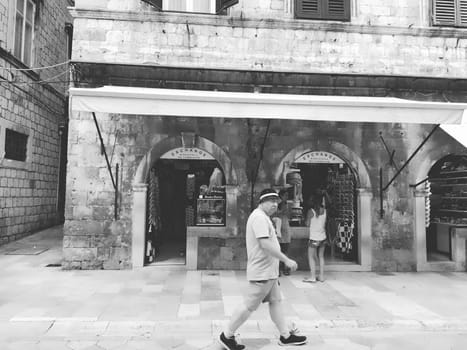 Stradun, Stradone is the main street of the historic city center of Dubrovnik in Croatia. architectural sights. A popular place for tourist walks. People are walking August 14, 2022 Black and white.