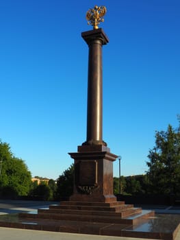 Petrozavodsk, Karelia, August 3, 2022 Monument-stele City of military glory, honorary title. Granite column with a bronze double-headed eagle. Pedestal on the alley of sister cities, Kirov Square.