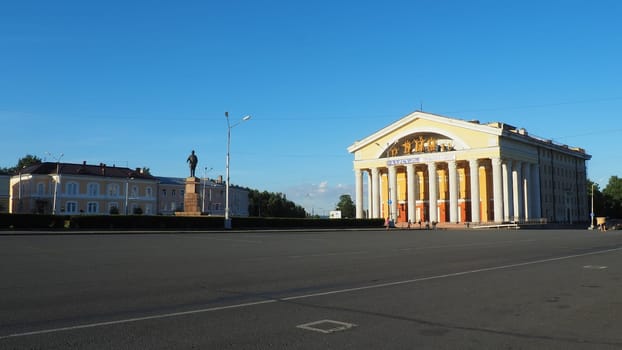 The Musical Theater of the Republic of Karelia is a state theater in Petrozavodsk. Cars drive along Kirov Square. People walk, children roller-skate on asphalt. Monument to S. M. Kirov. August 3 2022