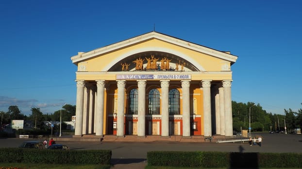 The Musical Theater of the Republic of Karelia, a state theater in Petrozavodsk. People and children are walking. August 3, 2022 Kirov Square. Facade with columns. Cars drive along Pushkinskaya street