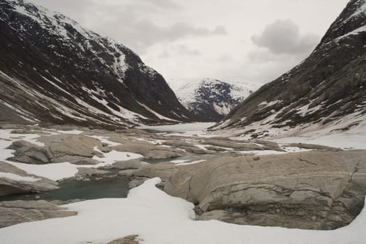 Glacier landscape with ice and rocks in Norway, illustrating retreating ice due to climate change. Beauty in nature.