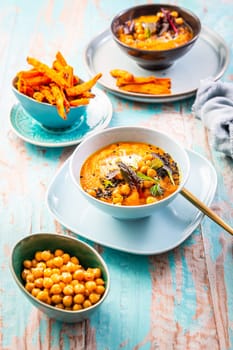 Carrot and sweet potato soup with chickpeas and fresh winter herbs, sweet potato fries