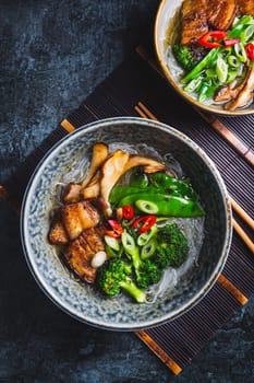 Ramen soup with mushrooms, vegetables, glass noodles and pork